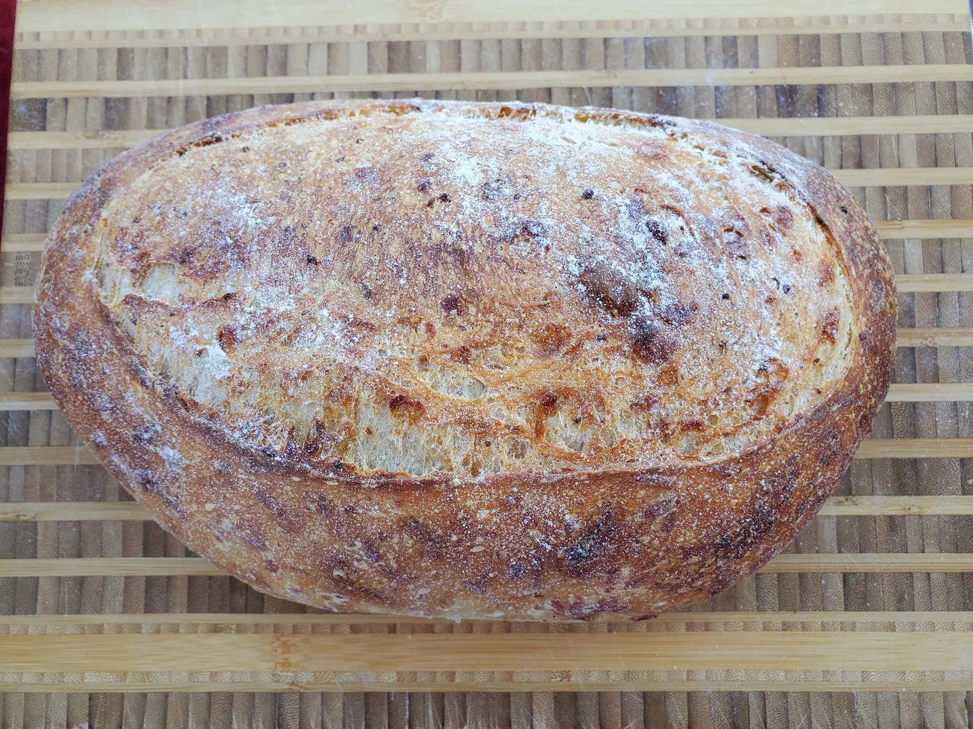 Garlic parmesan sourdough loaf with a rustic floured crust