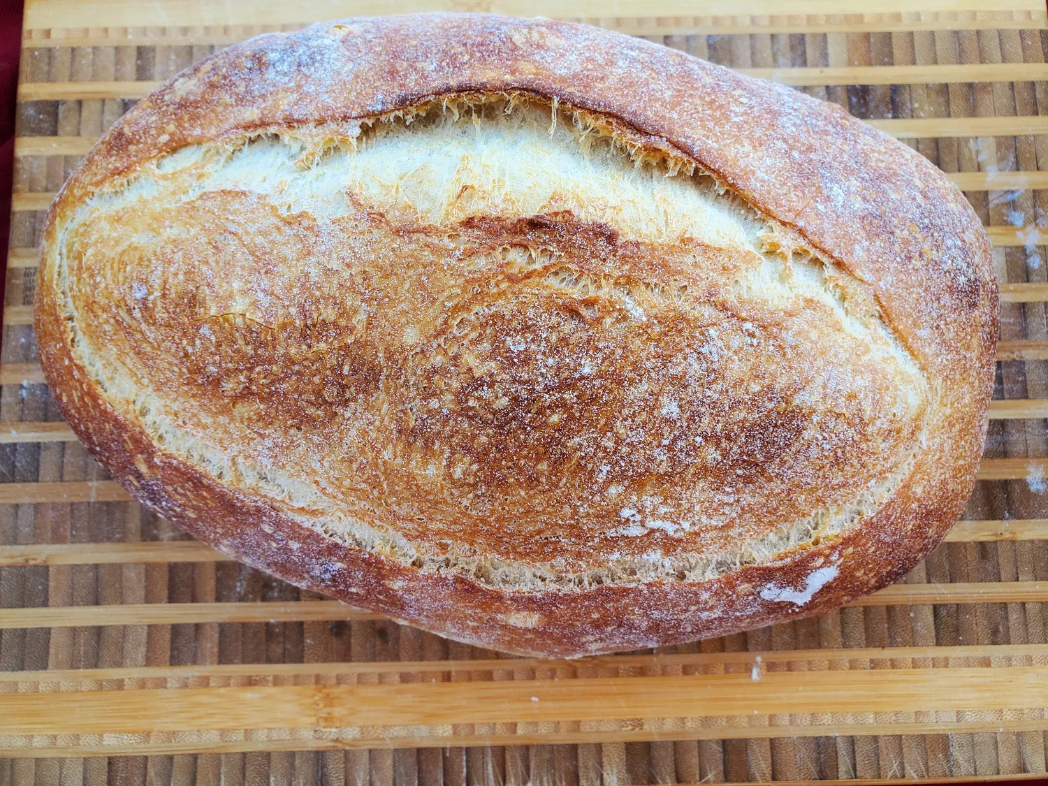 Traditional sourdough loaf with a deep golden, scored crust